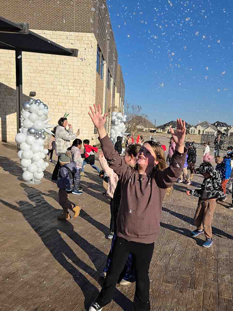Child Reaching for Foam Snow at a Dallas–Fort Worth Snow Party Child reaching up to touch falling artificial snow at a snow party in Dallas–Fort Worth