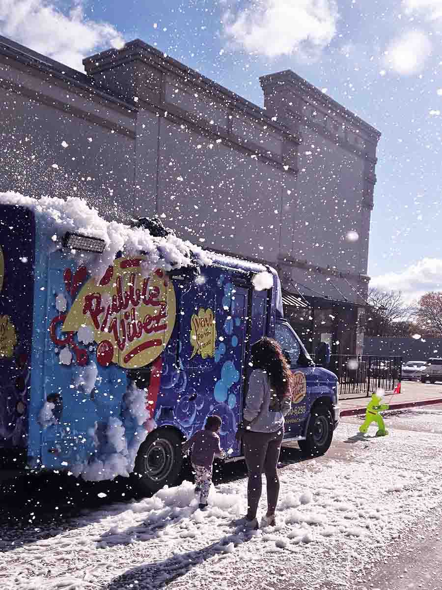 mobile-snow-party-truck-dallas-fort-worth-artificial-snow-bubble-vibez Mobile snow party truck creating artificial snowfall at a family event in Dallas–Fort Worth by Bubble Vibez